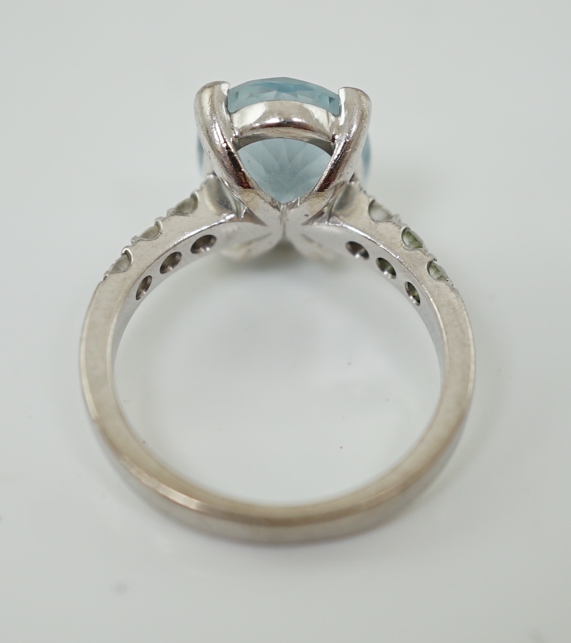 A modern 18ct white gold and single stone oval cut aquamarine set ring